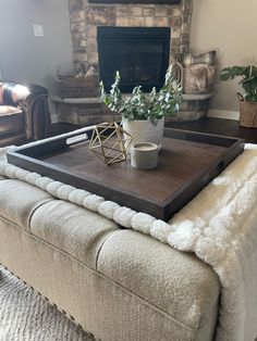 a living room with a couch, coffee table and fireplace