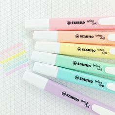 five different colored pens sitting next to each other