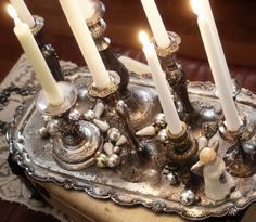 a silver tray with candles on top of it