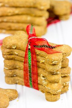 a stack of cookies with a red ribbon tied around the edges and on top of each other