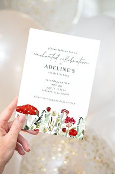 a person holding up a card that says, birthday celebration with flowers and mushrooms on it