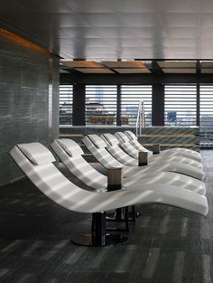 an airport waiting area with white chairs and windows