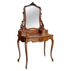 an antique wooden dressing table with mirror and drawers on it's legs, isolated against a white background