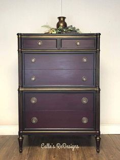 an old dresser is painted purple and gold