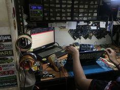 a man sitting at a desk working on a computer