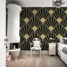 a bed room with a neatly made bed and a wallpapered design on the wall