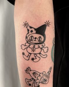 a person with a tattoo on their arm has a cat and dog design on it