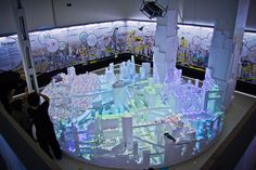 people are looking at an interactive model of a city