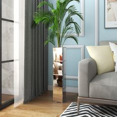 a living room scene with a couch and a potted plant