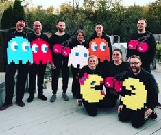 a group of people wearing pacman t - shirts with their faces painted on them