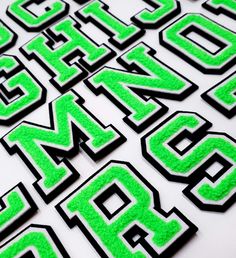 green and black letters are arranged in the shape of numbers