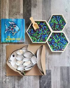 there are three bowls and two plates with food in them next to a children's book