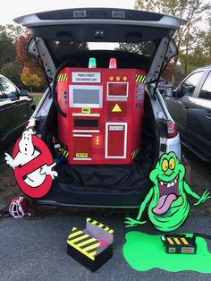 the back end of a car with its trunk open and various items in front of it