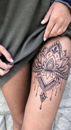 a woman's thigh with a tattoo on it and a flower in the middle