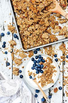 blueberries and granola on a plate next to a cookie sheet