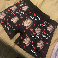 a pair of shorts with pictures of women's faces and hearts printed on them