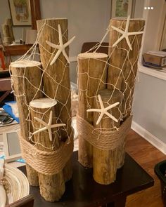 two wooden poles with rope wrapped around them and starfish decorations on top of them