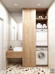 a washer and dryer in a bathroom with tile flooring on the walls