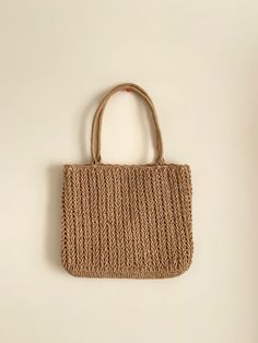 a woven bag hanging on the wall