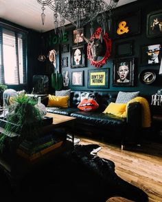 a living room with black walls and pictures on the wall, including an animal head