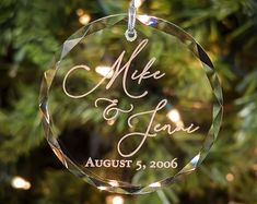 a personalized ornament hanging from a christmas tree