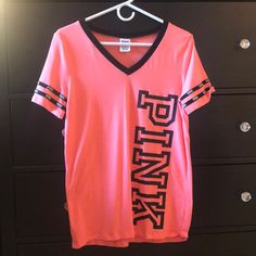 *Coral Pink Color Pink V-neck Graphic Tee Top, Pink V-neck Graphic Tee, Sporty Pink T-shirt With Logo Print, Pink V-neck T-shirt With Letter Print, Pink Athleisure T-shirt For Spring, Pink V-neck Athleisure Top, Pink V-neck Sports Top, Pink Letter Print Athleisure Top, Pink Athleisure Top With Letter Print