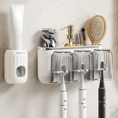 there are many toothbrushes in the holder on the wall next to each other