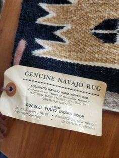 a label on the side of a rug that says genuine navajo rug