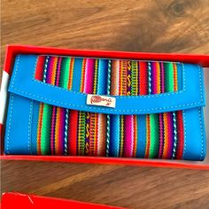 This New Wallet Comes In The Original Box. It Is A Beautiful Blue Multicolor Wallet. It Is Handmade By Peruvian Artesians It Is Made Of Leather And Fabric And It Measures Approximately 6 X 3 1/2” Blue Rectangular Clutch With Card Slots, Blue Rectangular Bag With Card Slots, Blue Travel Clutch Wallet, Blue Rectangular Coin Purse, Blue Bags With Card Slots For Gifts, Blue Bags With Card Slots For Gift, Blue Clutch With Card Slots As Gift, Blue Clutch With Card Slots For Gift, Multicolor Bifold Bags For Everyday Use