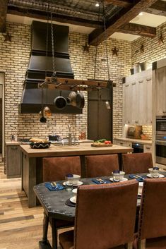 a kitchen with an oven, stove and dining room table set for four in it