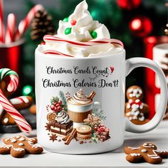 a coffee mug with christmas cookies and hot chocolate on it, surrounded by candy canes