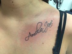 a woman with a tattoo on her chest that says, ameba jane in cursive writing