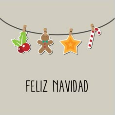 christmas decorations hanging on a clothes line with the words feliz navidad