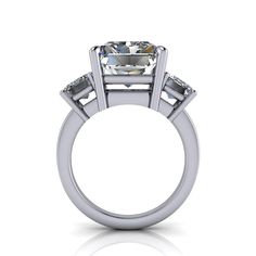 Solid Silver Cocktail ring shown with a 12x10mm, 8.00 ct. radiant cut colorless simulated diamond and (2) 7x5mm emerald cut colorless simulated diamonds, 2.00 ct. Band width 2.2mm.10.00 carat total weight. *Sterling Silver is Rhodium dipped to reduce tarnishing. Rhodium is a very strong metal that creates a protective layer over the sterling silver, making it more resistant to tarnishing. *Custom made at the time of order. Mens Gemstone Rings, Rings Mens Wedding Bands, Simulated Diamond Rings, White Gold Set, Forever One Moissanite, Colorless Diamond, Lab Grown Diamonds Engagement, Black Diamond Ring, Moissanite Earrings