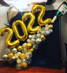 balloons and champagne are arranged in the shape of a number for a new year's eve celebration