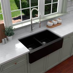 a black kitchen sink sitting under a window