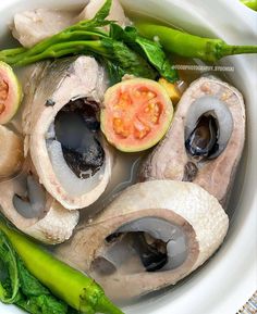 a bowl filled with meat and vegetables on top of a table