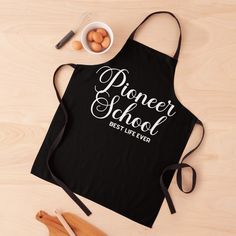 a black apron with the words'proper school, best life ever'on it