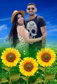 a couple standing next to each other with sunflowers in the foreground