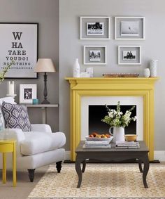 a living room with yellow furniture and pictures on the wall above it's fireplace