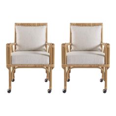 a pair of chairs with wheels on the back and seat upholstered to each other