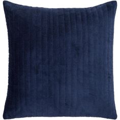 a blue velvet pillow on a white background