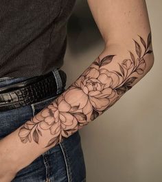 a woman with a flower tattoo on her arm