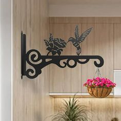 a wall mounted shelf with flowers and two birds on it