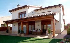 a large house with a covered patio in the front yard