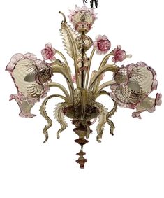 an ornate chandelier with pink flowers and leaves on the bottom half of it