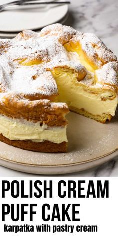 a cake with powdered sugar on top and the words polish cream puff cake below it