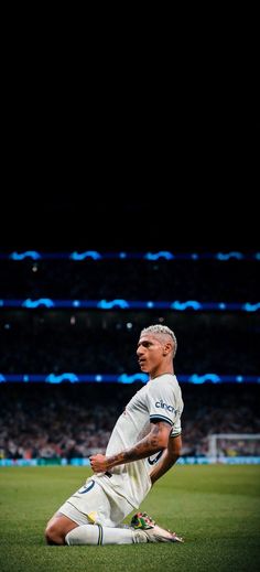 a man sitting on top of a soccer field