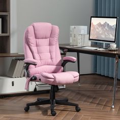 a pink office chair sitting in front of a computer desk with a monitor on it