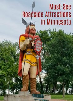 a statue of a man holding a shield and spear with the words must see roadside attractions in minnesota